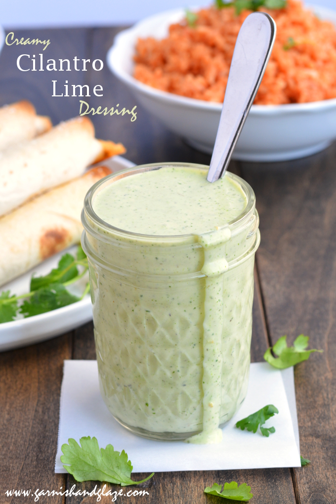 Cilantro Lime Dressing in a small mason jar with a spoon in it.