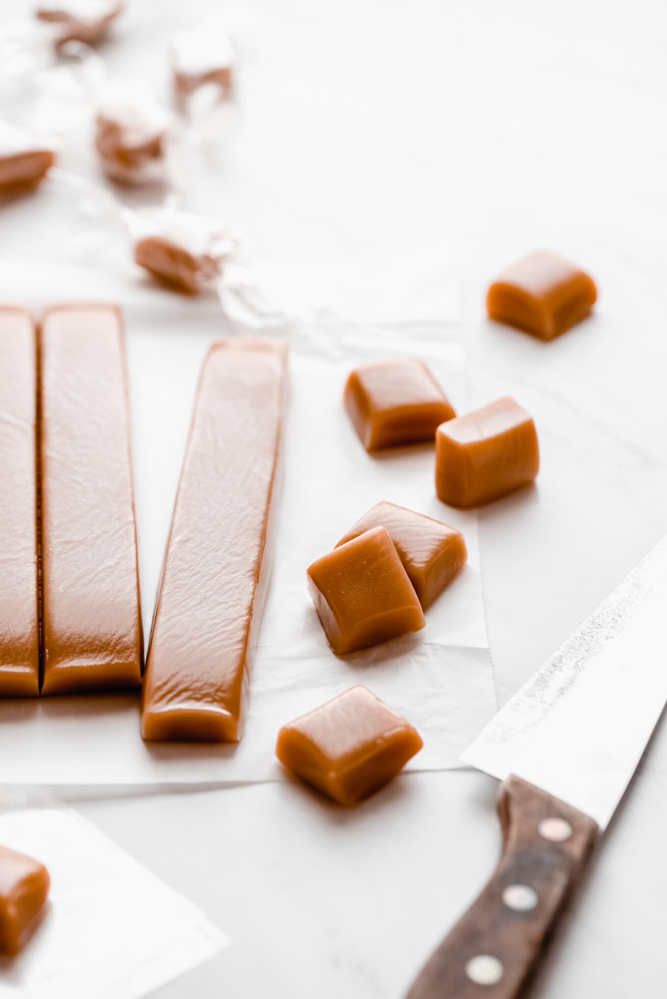 Homemade caramel cut up into squares ready to wrap.