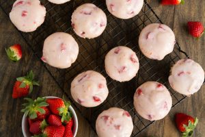 Glazed Strawberry Muffins- Soft and tender muffins filled with fresh strawberries and dipped in a sweet strawberry glaze | Garnish & Glaze