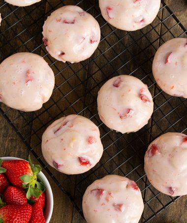 Glazed Strawberry Muffins- Soft and tender muffins filled with fresh strawberries and dipped in a sweet strawberry glaze | Garnish & Glaze