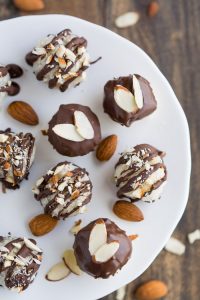 Almond Joy Macaroons- Mini macaroons stuffed with an almond and then dipped and drizzled with chocolate | Garnish & Glaze
