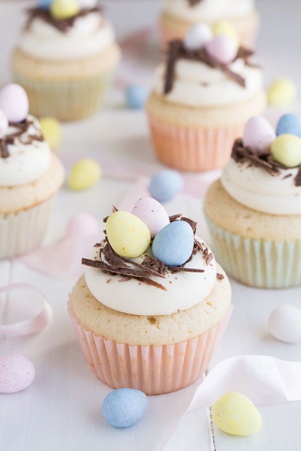 A colorful array of Easter cupcakes with bunny, carrot, and chocolate decorations, perfect for Easter dessert ideas.