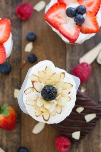 Fresh fruit mixed into vanilla Snack Packs and topped with an arrangement of berries and almonds in the shape of a flower. #SnackPackMixins #Ad