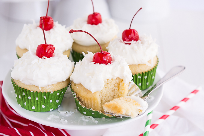 Vanilla cupcakes infused with three milks and topped with homemade whipped cream, coconut, and cherries.