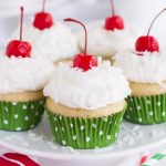 Vanilla cupcakes infused with three milks and topped with homemade whipped cream, coconut, and cherries.