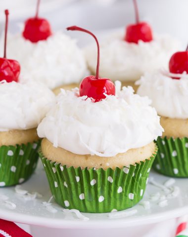 Vanilla cupcakes infused with three milks and topped with homemade whipped cream, coconut, and cherries.