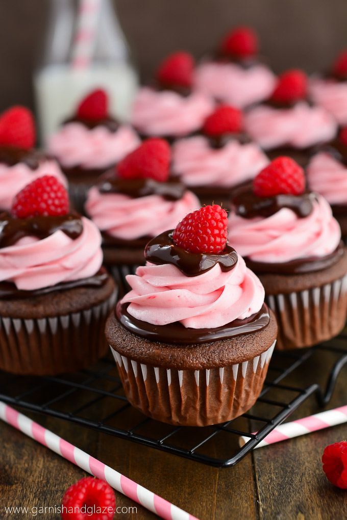 Rich chocolate cupcakes topped with chocolate ganache and raspberry cream cheese frosting