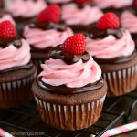 Rich chocolate cupcakes topped with chocolate ganache and raspberry cream cheese frosting