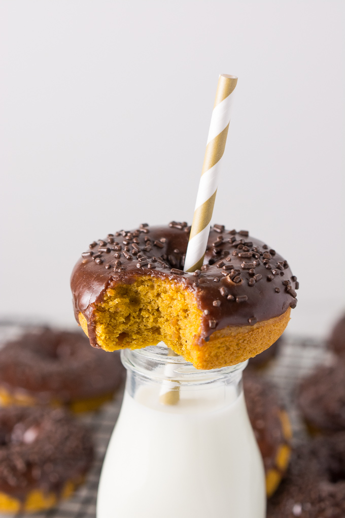 Baked pumpkin doughnuts topped with chocolate icing and chocolate sprinkles.