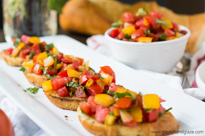 Tomato Basil Bruschetta made with home grown tomatoes, ribbons of basil, and a bit of balsamic vinegar served on buttery toasted French bread.