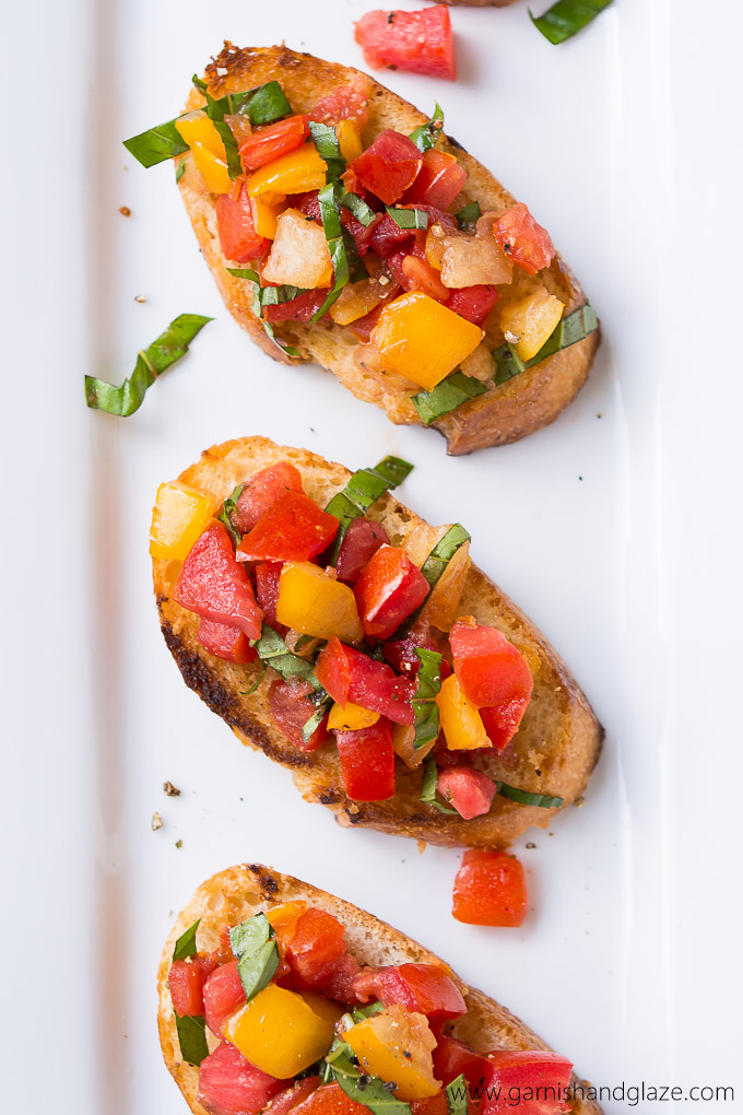 Tomato Basil Bruschetta made with home grown tomatoes, ribbons of basil, and a bit of balsamic vinegar served on buttery toasted French bread.