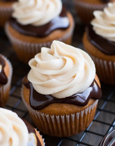 A perfectly moist pumpkin cupcake covered in rich chocolate ganache and topped with cinnamon cream cheese frosting.