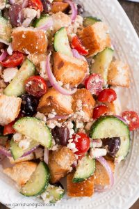 Make Greek Panzanella to use up your leftover French bread in this veggie filled summer salad.