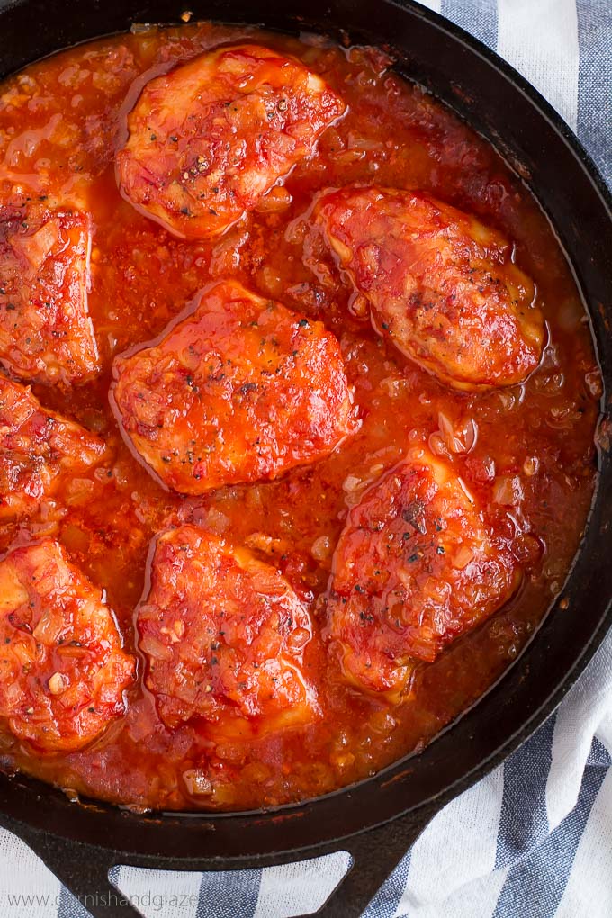 Napa Valley Chicken and sweet tomato onion sauce in a skillet.