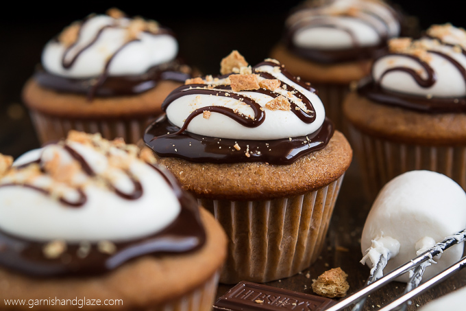 Celebrate National S'mores Day with S'mores Cupcakes that have milk chocolate ganache and fluffy marshmallow frosting on top of a graham cracker cake.