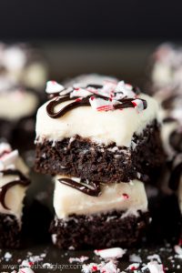 Enjoy the holidays with these rich dark chocolate Cream Cheese Peppermint Brownies topped with a delicious cream cheese frosting, ganache, and crushed candy cane.