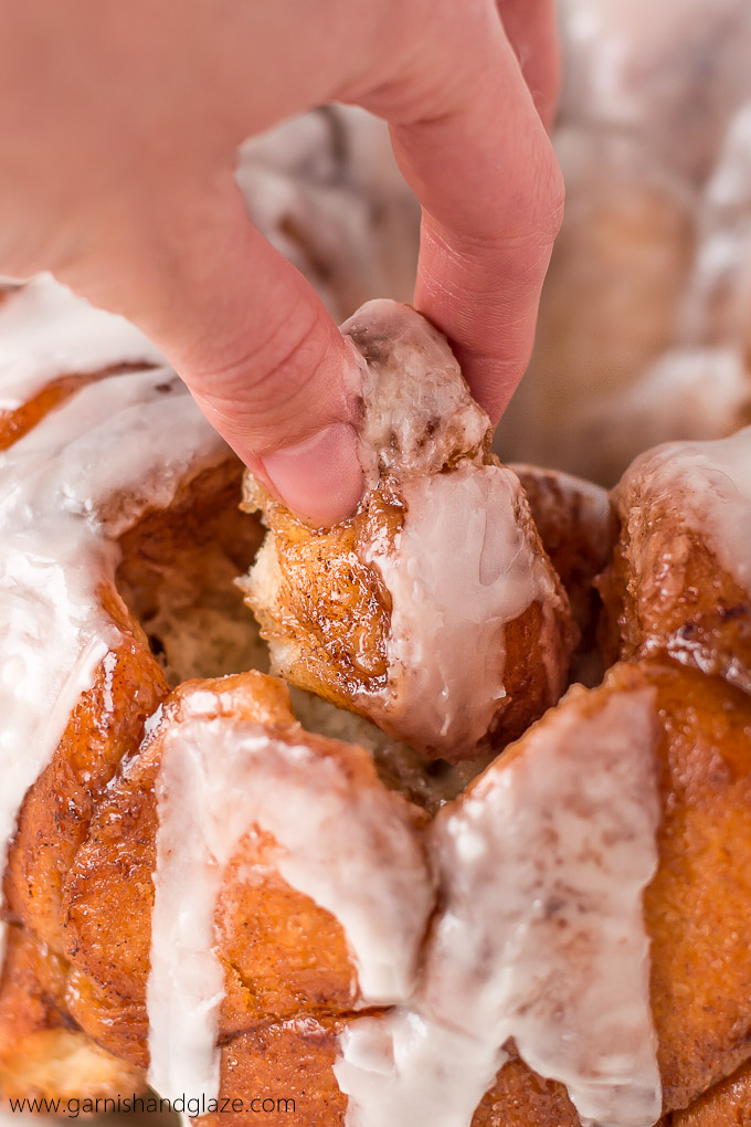 Gather round the table with your family for some Glazed Monkey Bread-- irresistible fluffy, buttery, cinnamon and sugar coated balls of bread, covered in a creamy glaze.