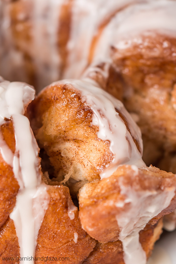 Gather round the table with your family for some Glazed Monkey Bread-- irresistible fluffy, buttery, cinnamon and sugar coated balls of bread, covered in a creamy glaze.