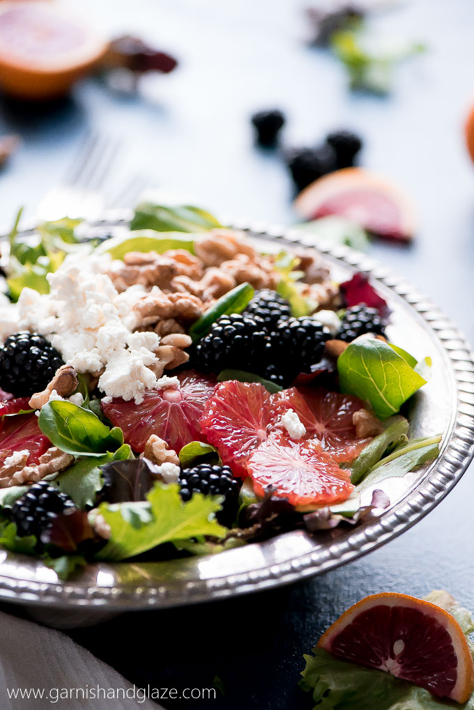 Grab a bowl of this BLACKBERRY BLOOD ORANGE SALAD with blood orange vinaigrette, creamy goat cheese, and toasted walnuts. Eating healthy never tasted so good!