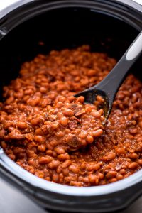 Slow Cooker Baked Beans are a delicious and easy made-from-scratch side dish that tastes fantastic next to your favorite burger.