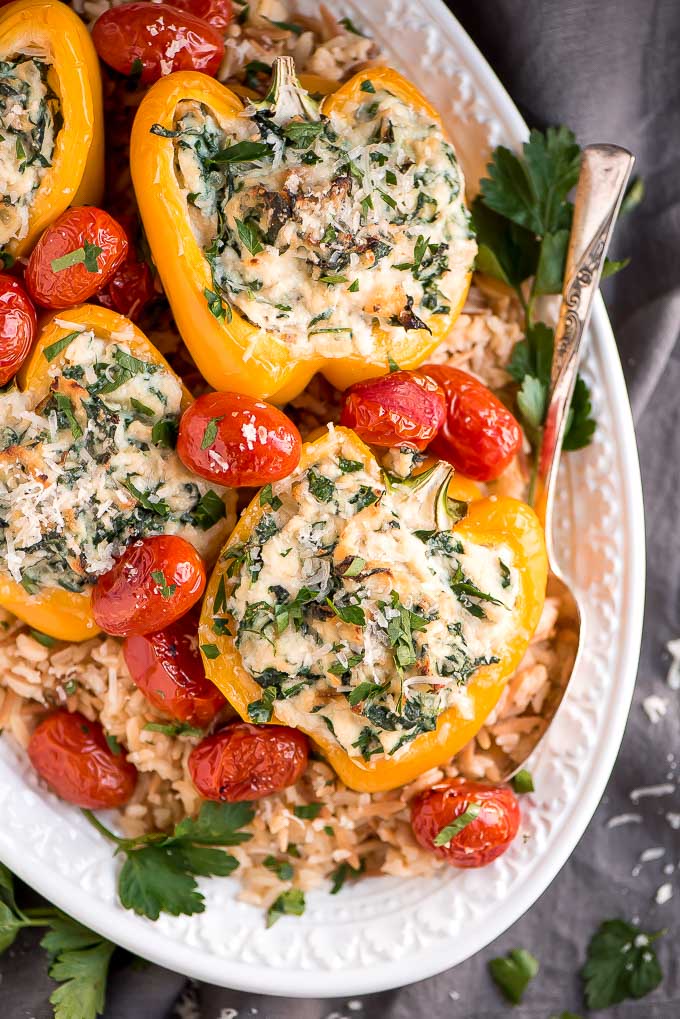 Enjoy these easy-to-make Vegetarian Spinach Ricotta Stuffed Peppers with Blistered Tomatoes for a beautiful and healthy vegetarian meal.