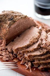 Dinner just got better with these Slow Cooker French Dip Sandwiches with hearty beef and melted provolone cheese on a toasted bun and dipped in au jus.