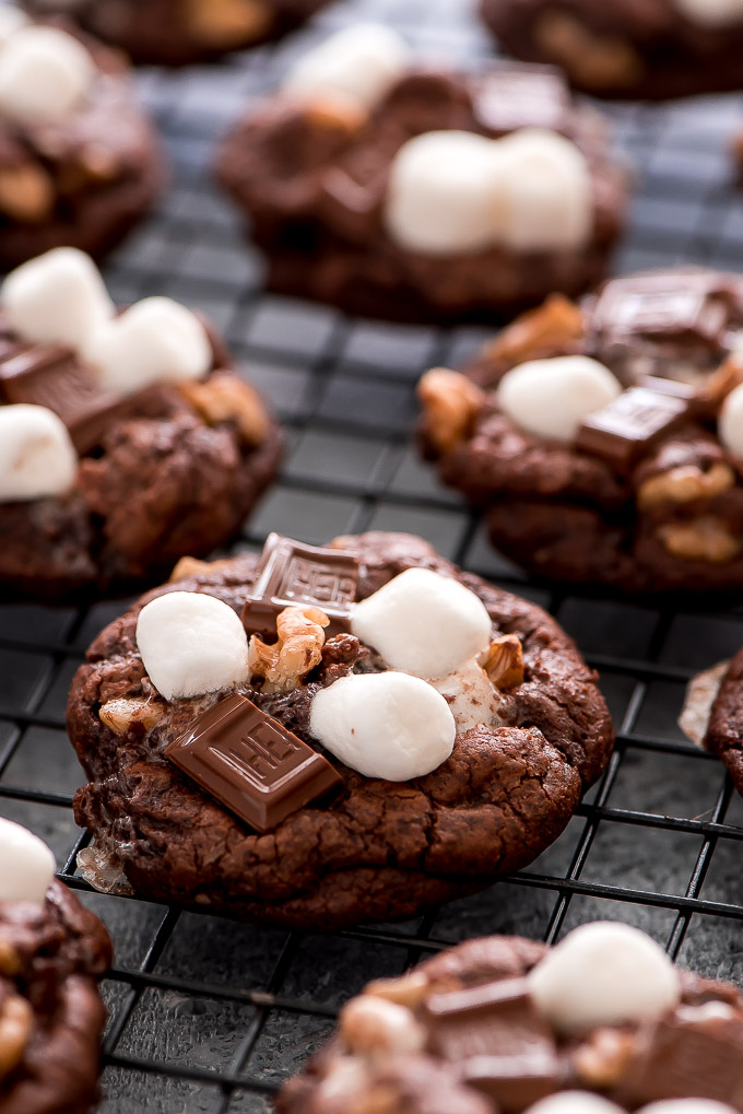 Rocky Road Cookies on cooling rack. Chocolate cookies loaded with marshmallows, chocolate chunks, and walnuts.