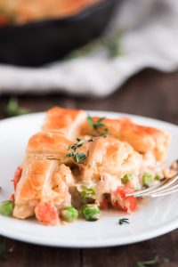 Slice of Easy Chicken Pot Pie with a golden puff pastry crust