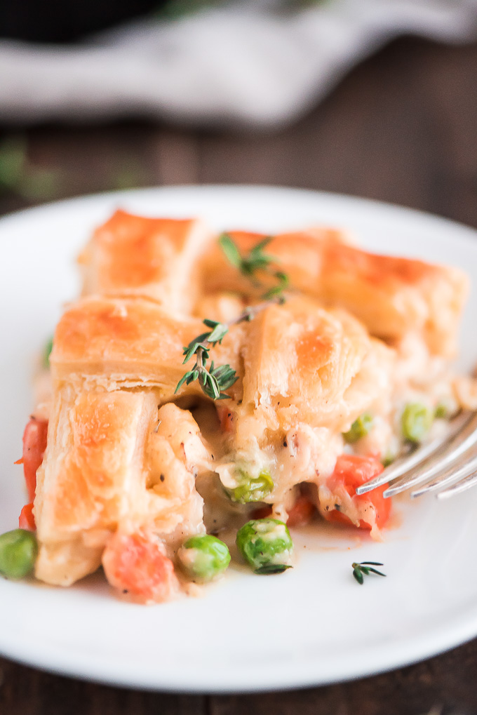Close up slice of Easy Chicken Pot Pie with a golden puff pastry crust