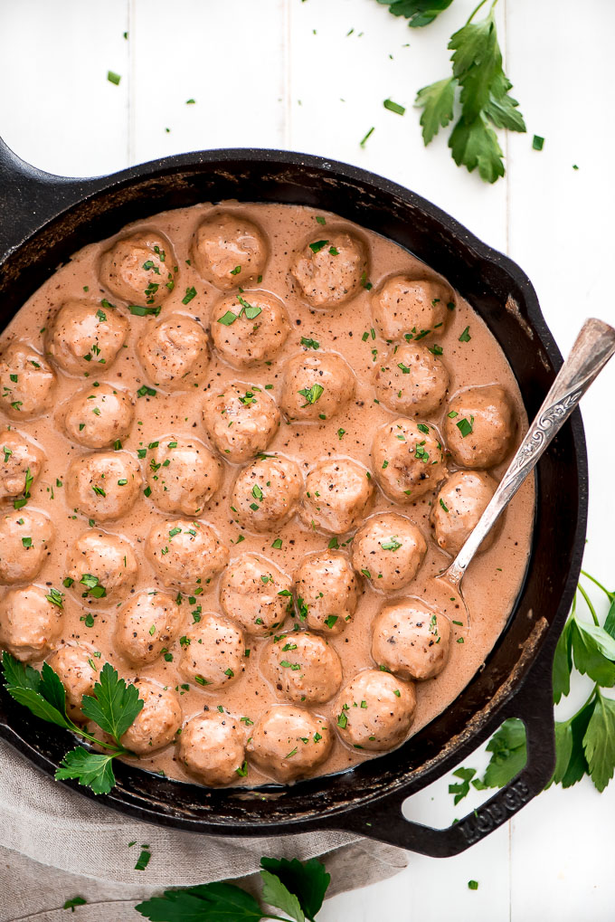 Pan of easy Swedish Meatballs garnished with parsley.