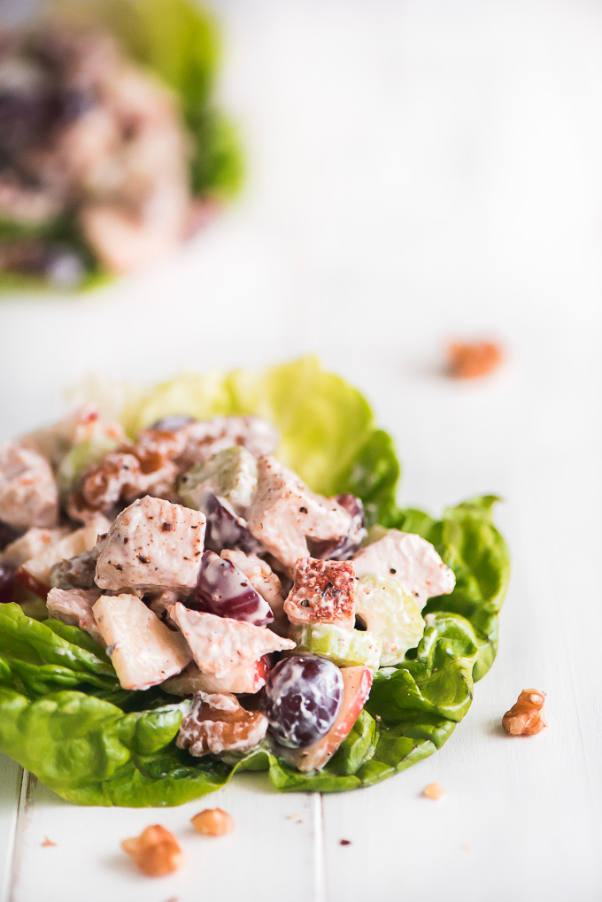 Close up of Chicken Waldorf Salad on a leaf of Boston lettuce.