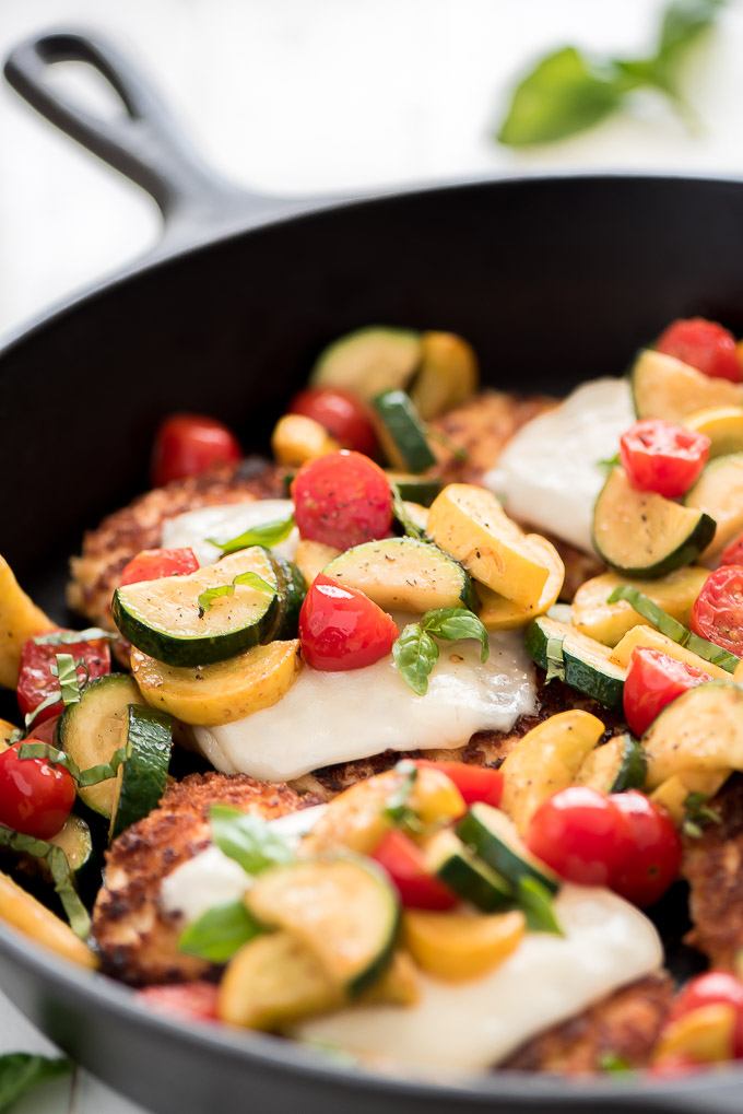 Parmesan Crusted Chicken topped with mozzarella cheese, zucchini, squash, tomatoes, and basil.