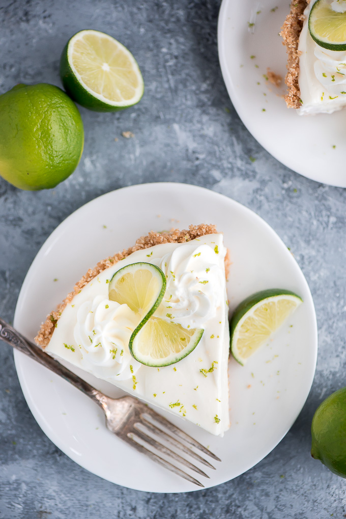 No Bake Key Lime Pie with graham cracker crust on a plate ready to dig into.