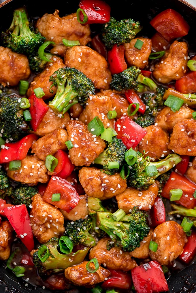 Copycat General Tso Chicken with bell peppers, broccoli, and green onions.