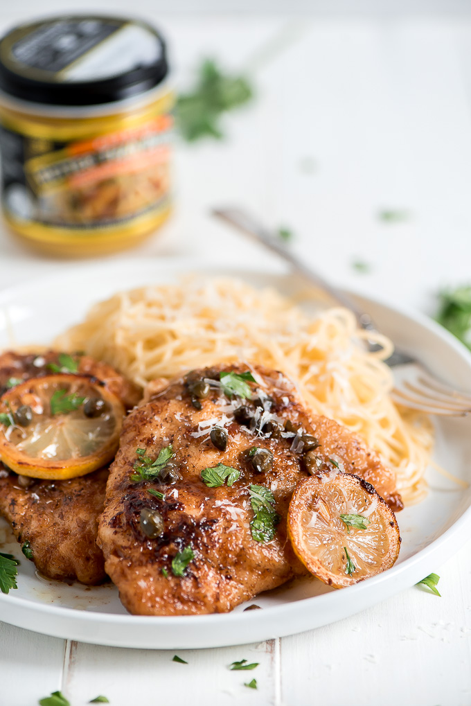 Plated Lemon Chicken Piccata with angel hair pasta.