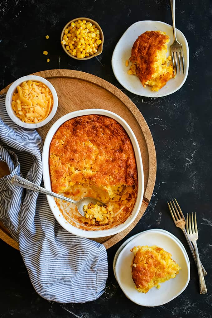 Cheesy Corn Casserole in a casserole dish and on plates.