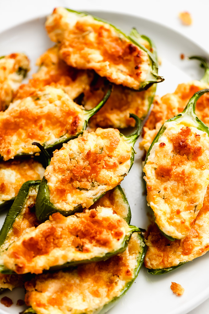 A plate full of Crispy Baked Jalapeño Poppers covered in a crispy topping.
