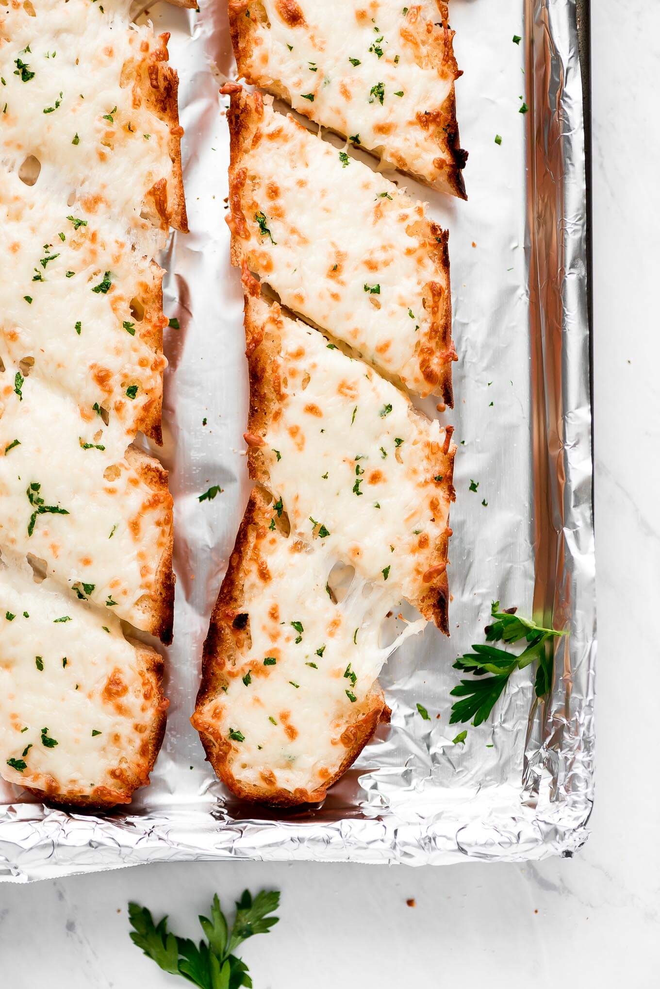 french bread sprinkled with parsley and cheese and broiled until melted and golden brown.