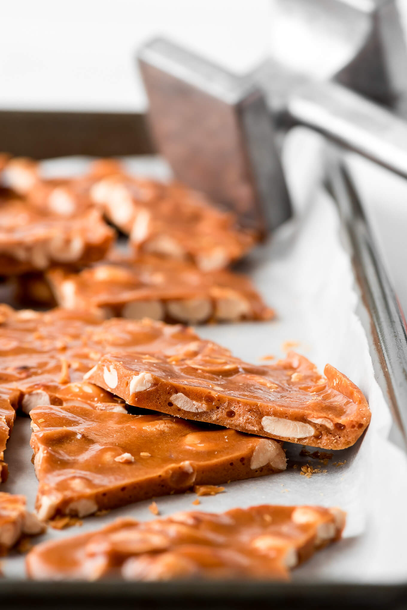 A close up shot of the inside of Peanut Brittle showing off the peanuts and air bubbles.