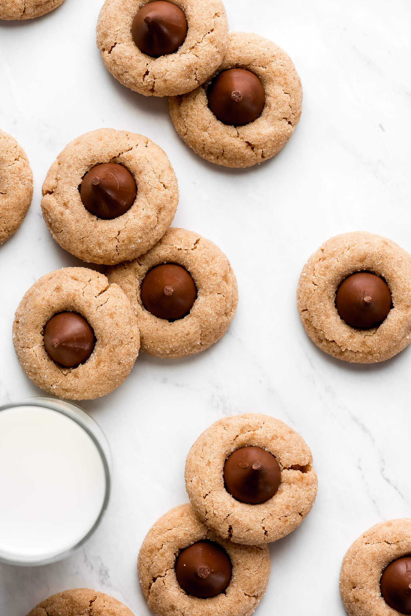 Top view of Peanut Butter Kiss Cookies and a glass of milk.