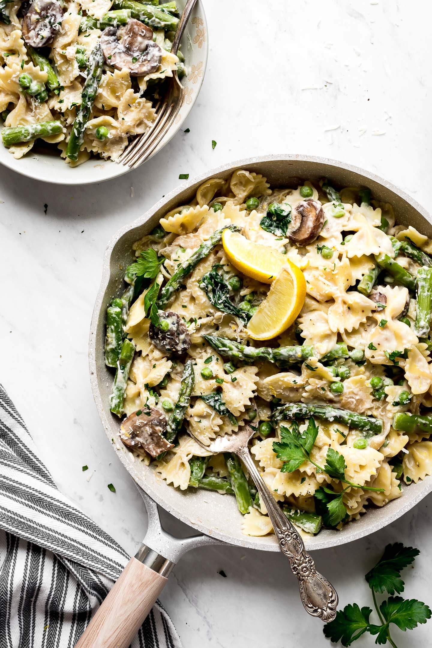 A large skillet of Creamy Asparagus Pasta with lemons.