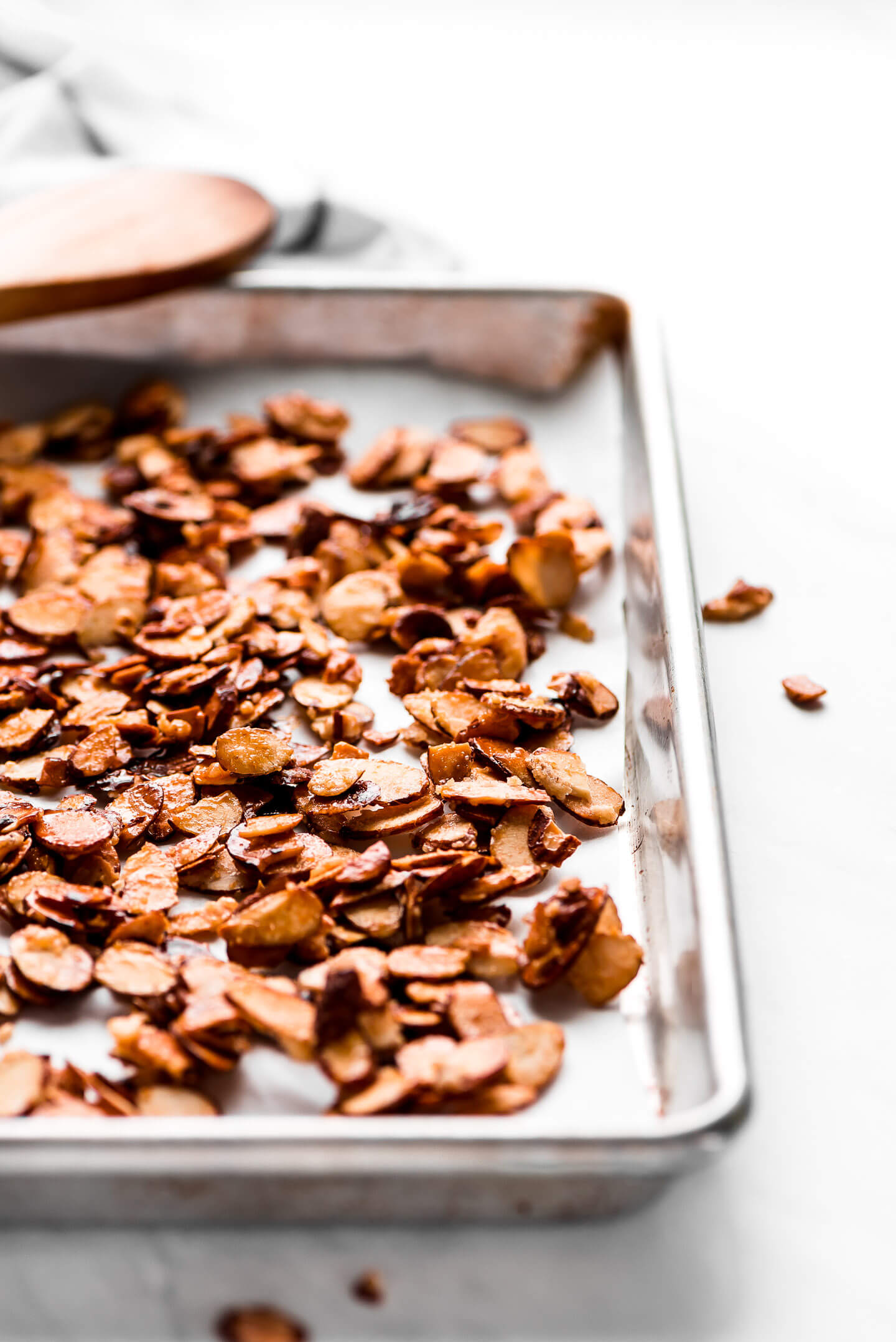 Close up shot of sugar glazed almonds on a baking sheet.