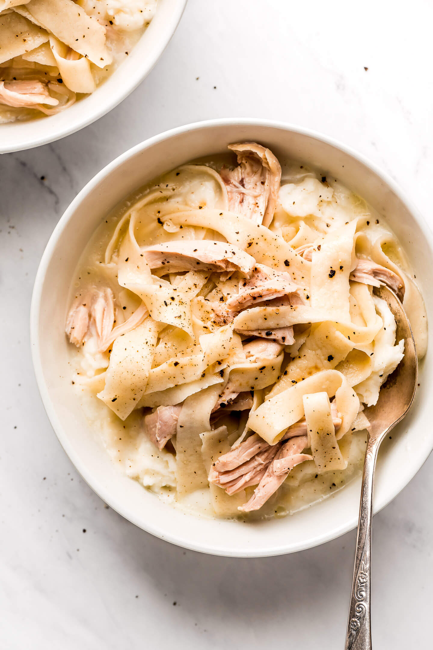 A bowl of Amish Chicken and Noodles over mashed potatoes.
