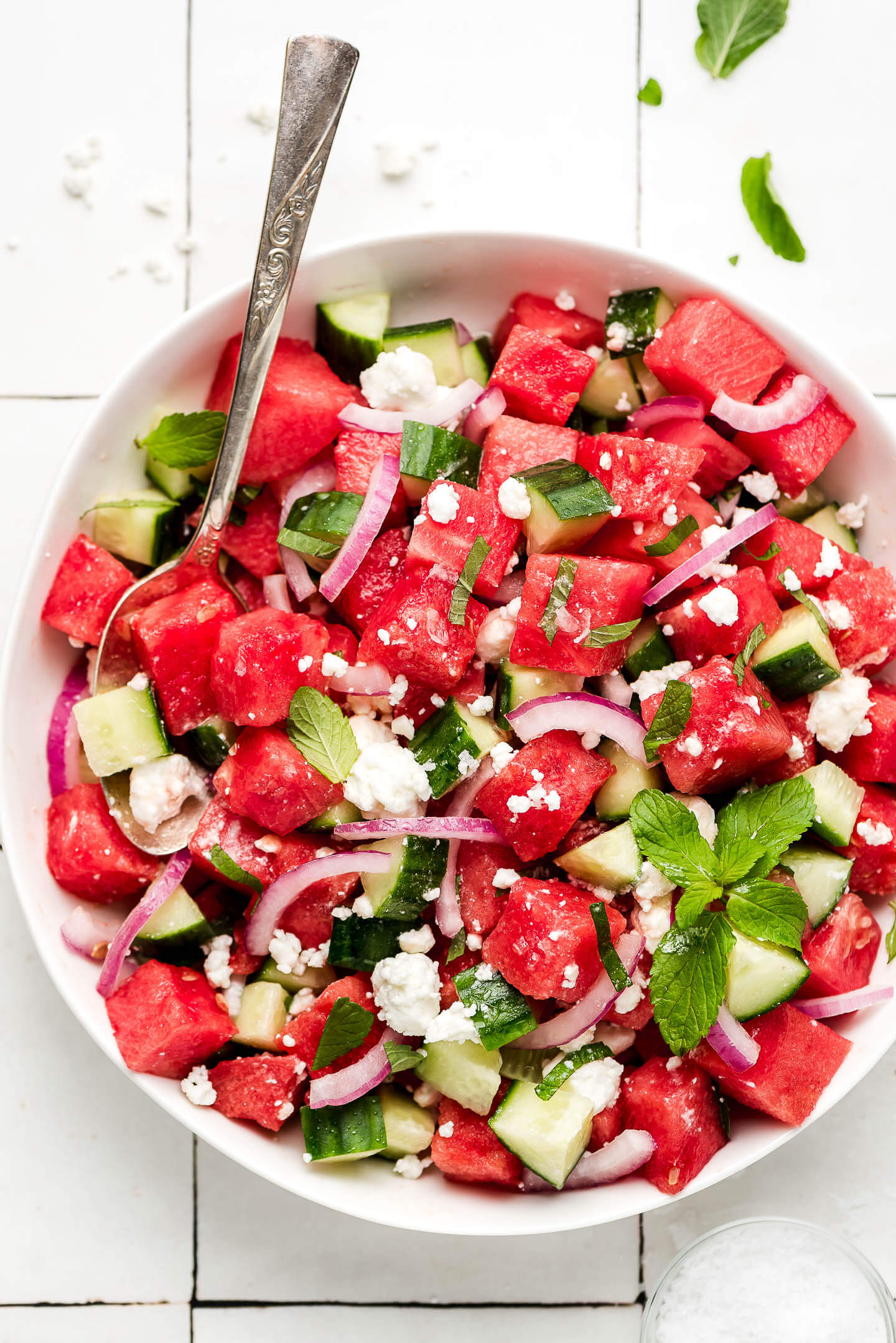 A bowl of Watermelon Salad with mint, red onions, and feta cheese.