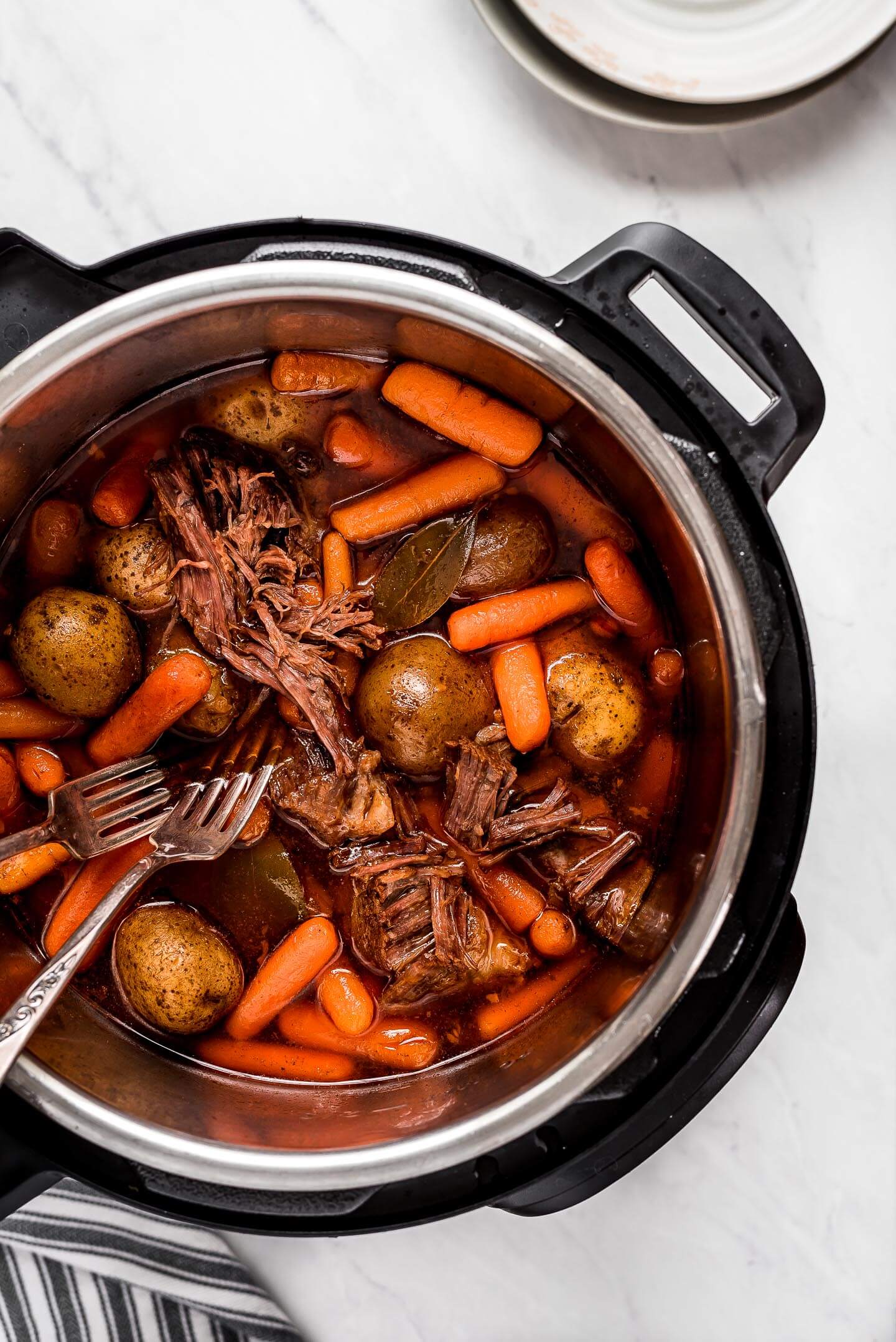 Beef, potatoes, carrots, and broth in an Instant Pot.