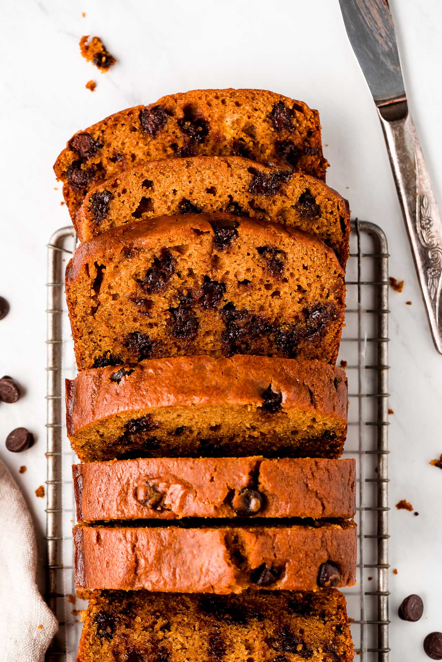 Pumpkin Chocolate Chip Bread sliced and showing moist inside studded with chocolate chips.
