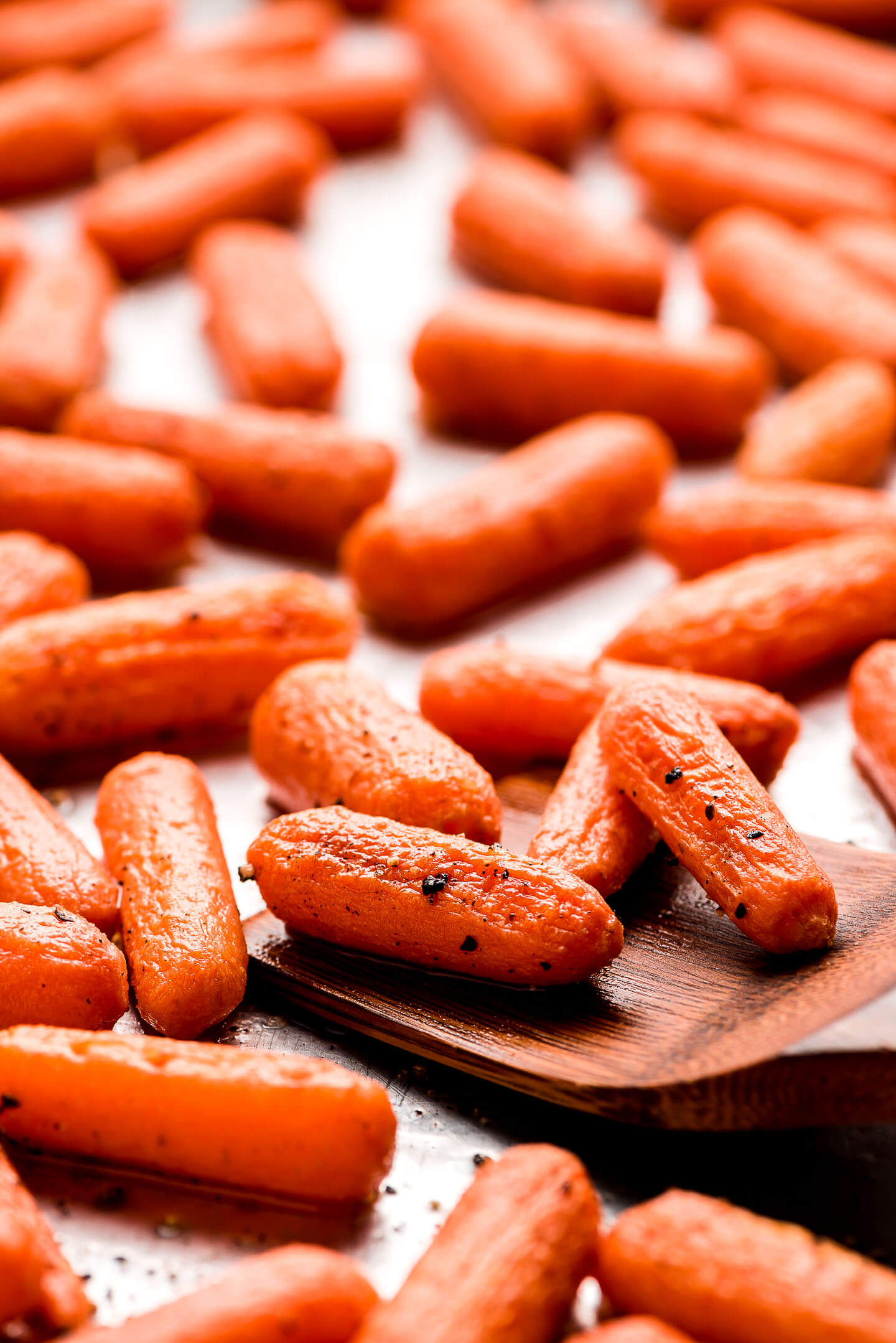 Close up shot of roasted carrots with salt and pepper.