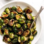 A serving bowl of Roasted Brussel Sprouts with Balsamic Glaze.