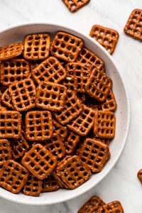 Square pretzel snaps in a bowl.