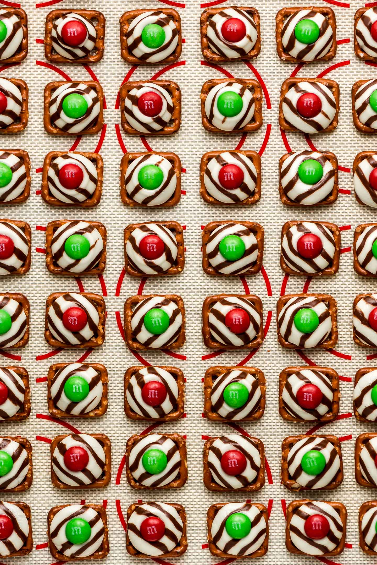 Square pretzels topped with a melted Hug and red & green M&M's